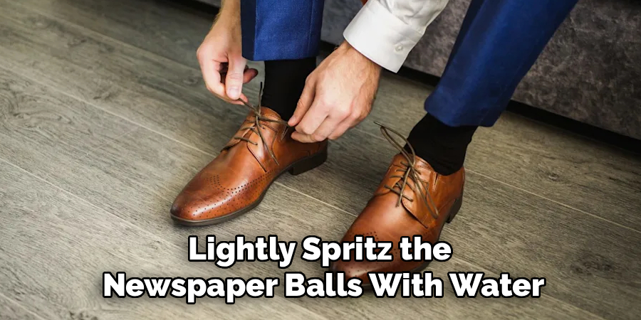 Lightly Spritz the 
Newspaper Balls With Water